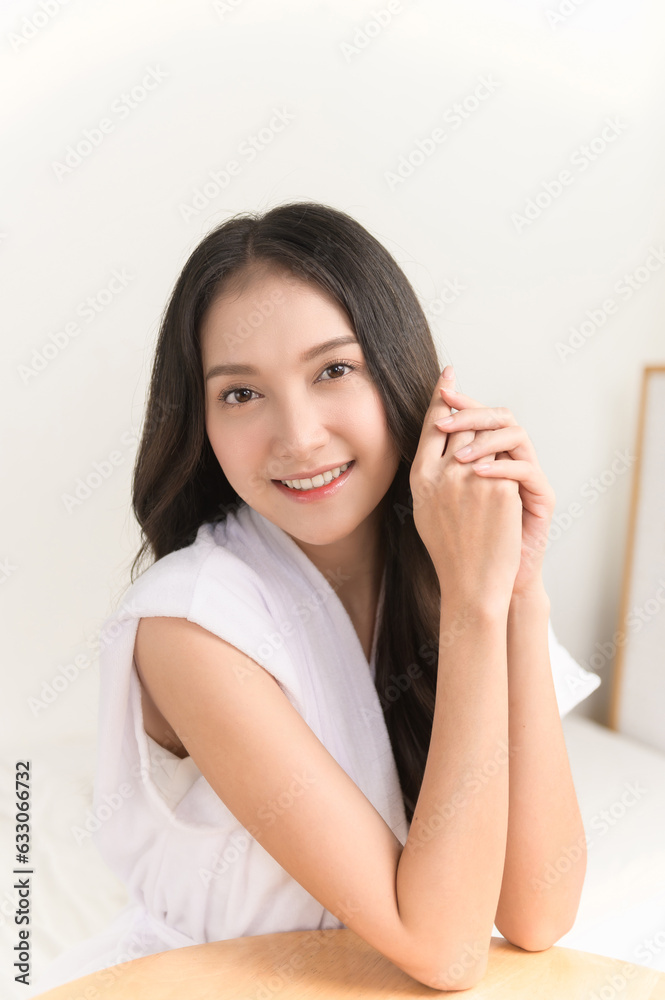 Portrait photo of young beautiful Asian woman taking care of her facial skin after apply face skin care cosmetic lotion moisturizer product and checking in mirror at home. Beauty care concept Portrait photo of young beautiful Asian woman taking care of her facial skin after apply face skin care cosmetic lotion moisturizer product and checking in mirror at home. Beauty care concept
