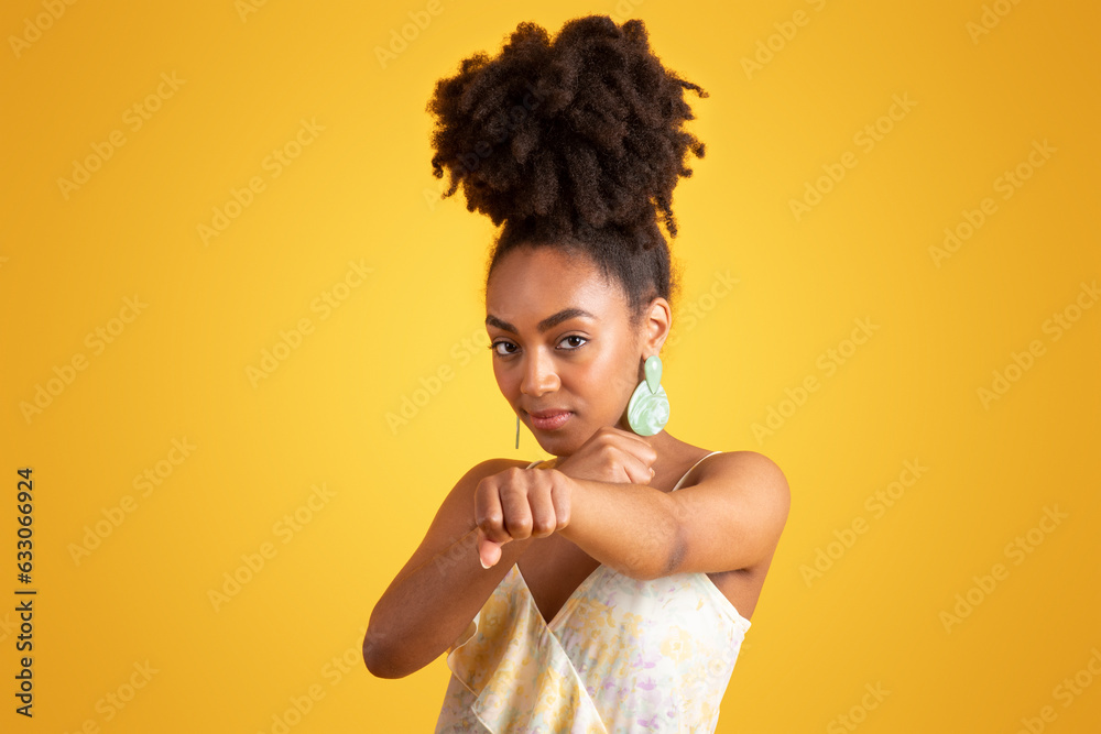 Strong confident serious millennial black lady doing punch, fist fight Strong confident serious millennial black lady doing punch, fist fight