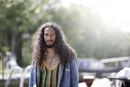 Young man with long hair in park photo