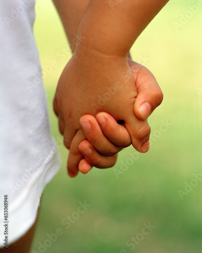 Toddlers holding hands photo