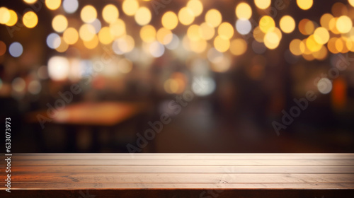 Empty wooden tabletop and defocused background with bokeh lights blurred backdrop of street cafe and beer pub.