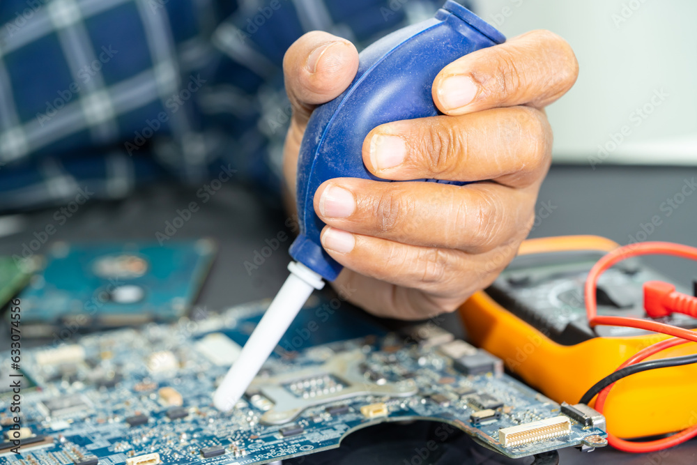 Obraz premium Asian technician repair and cleaning dirty micro circuit main board of smartphone electronic technology with brush, hardware, mobile phone, upgrade concept.