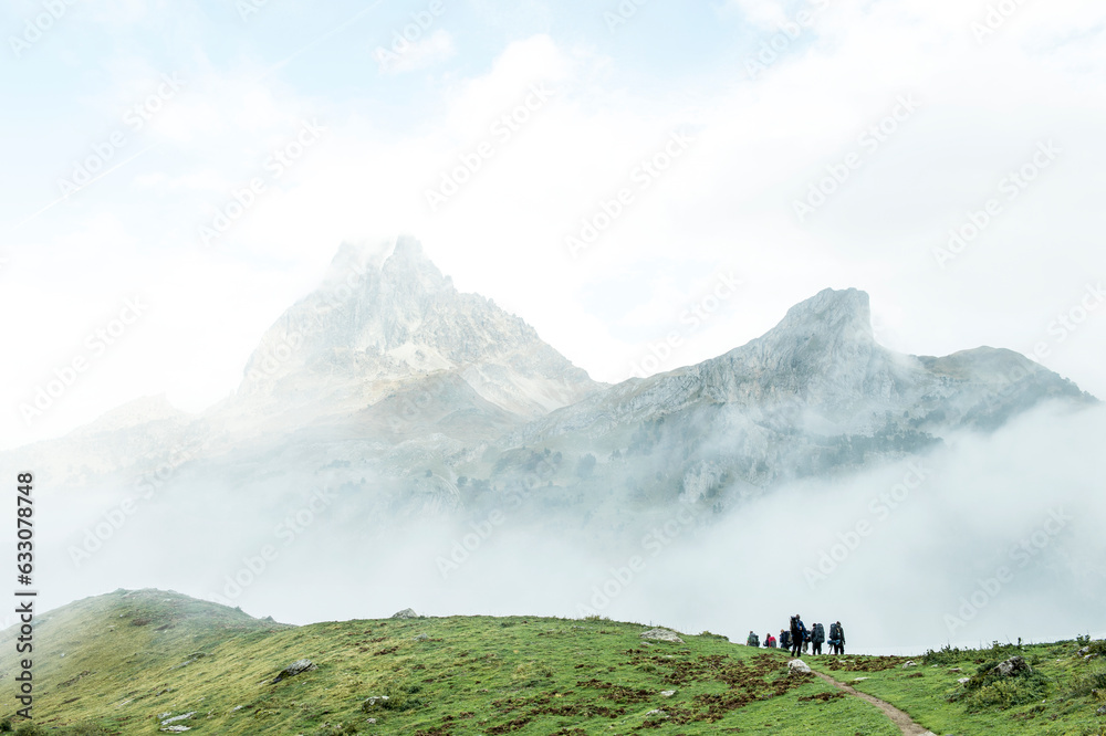 People hiking in mountain field People hiking in mountain field