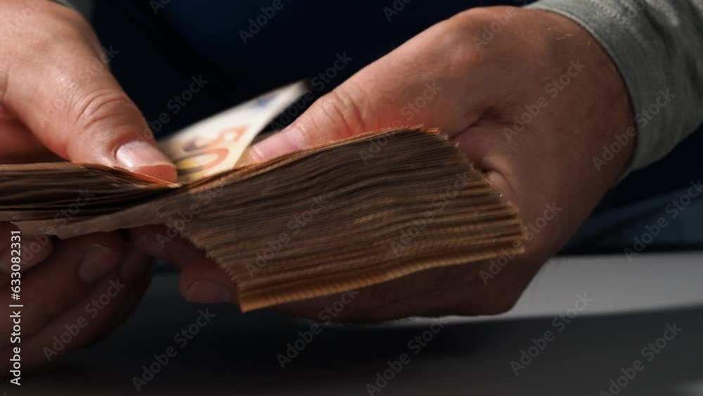 A stack of 50 euro banknotes in hands, the concept of savings banks, banking, paying taxes and money circulation. EU money.