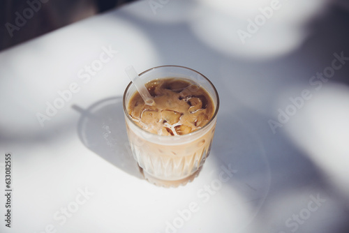 Iced coffee on white table