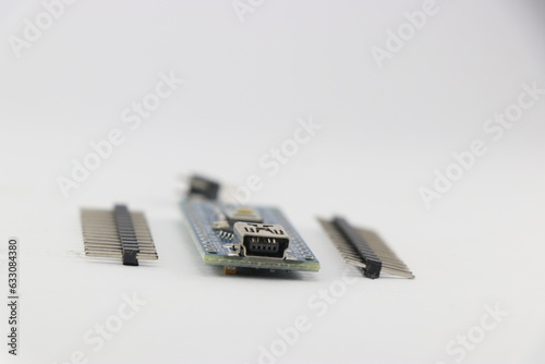 Programmable micro controller board with the unsoldered pins isolated on white background photo