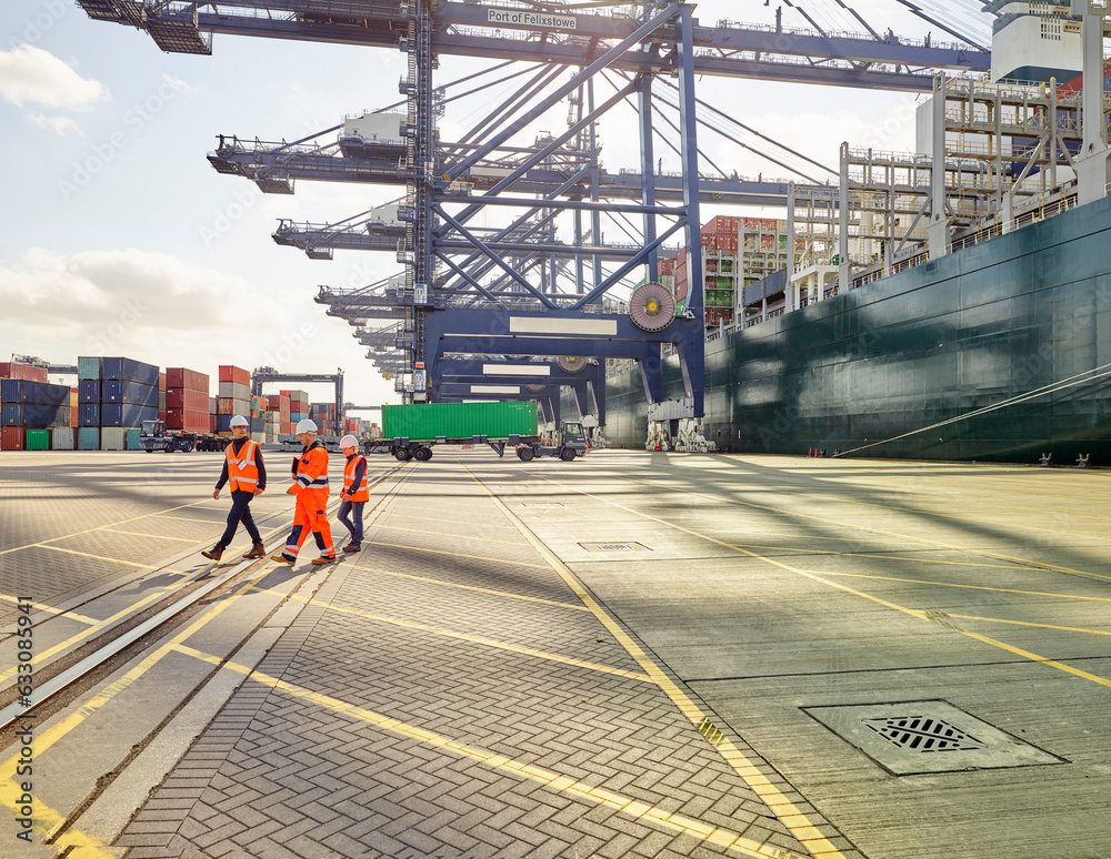 Dock team workers and supervisor walking away from cargo ship and ...