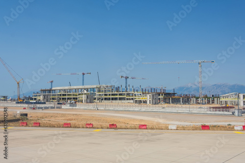 Wallpaper Mural Construction of a new airport terminal building, view of cranes machinery and aircraft parked around. Transport hub reconstruction. Torontodigital.ca
