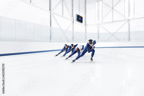 A team of speed skaters practicing at an at ice rink photo