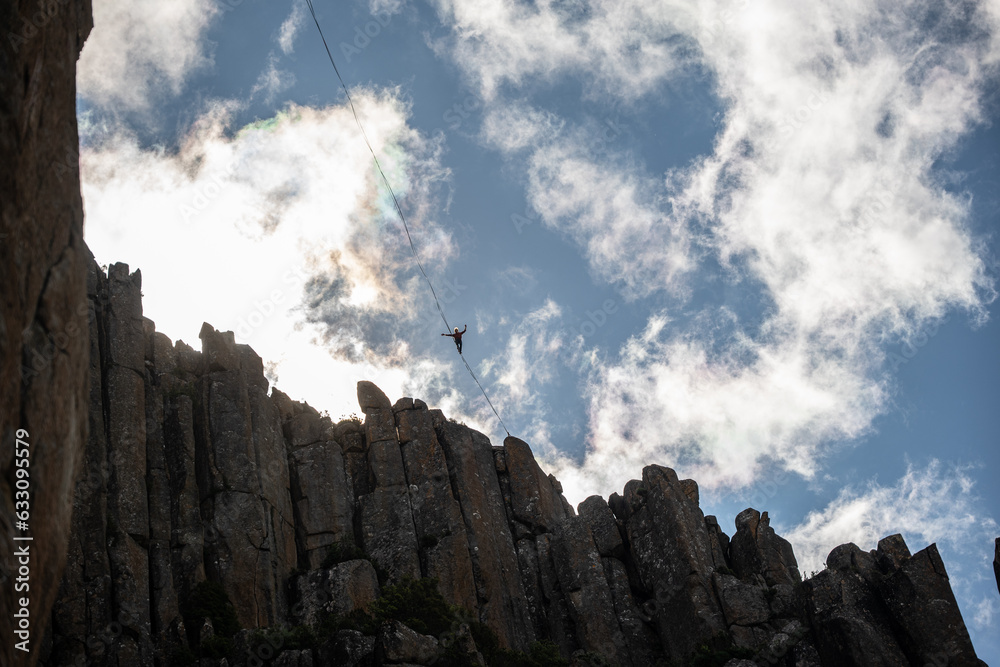Fototapeta premium Person on a slackline/highline in the mountains