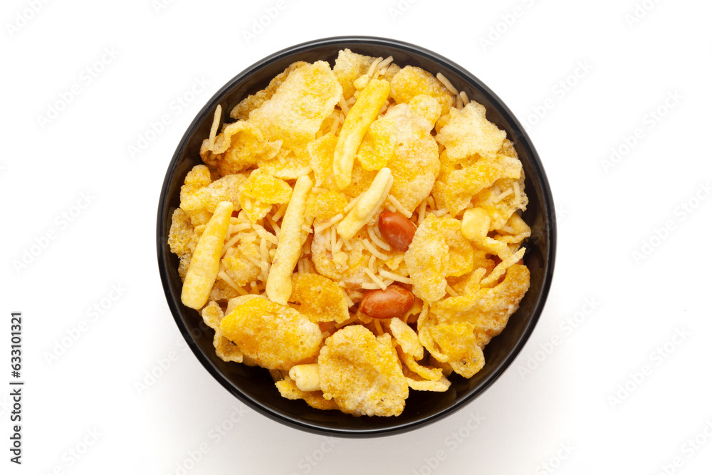 Close-up of Cornflakes Mixture Indian namkeen (snacks) on a ceramic black bowl. Isolated on white background. Top view Close-up of Cornflakes Mixture Indian namkeen (snacks) on a ceramic black bowl. Isolated on white background. Top view