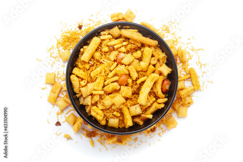 Close-up of Gadbad Indian namkeen (snacks) on a ceramic black bowl. Isolated on white background. Top view photo