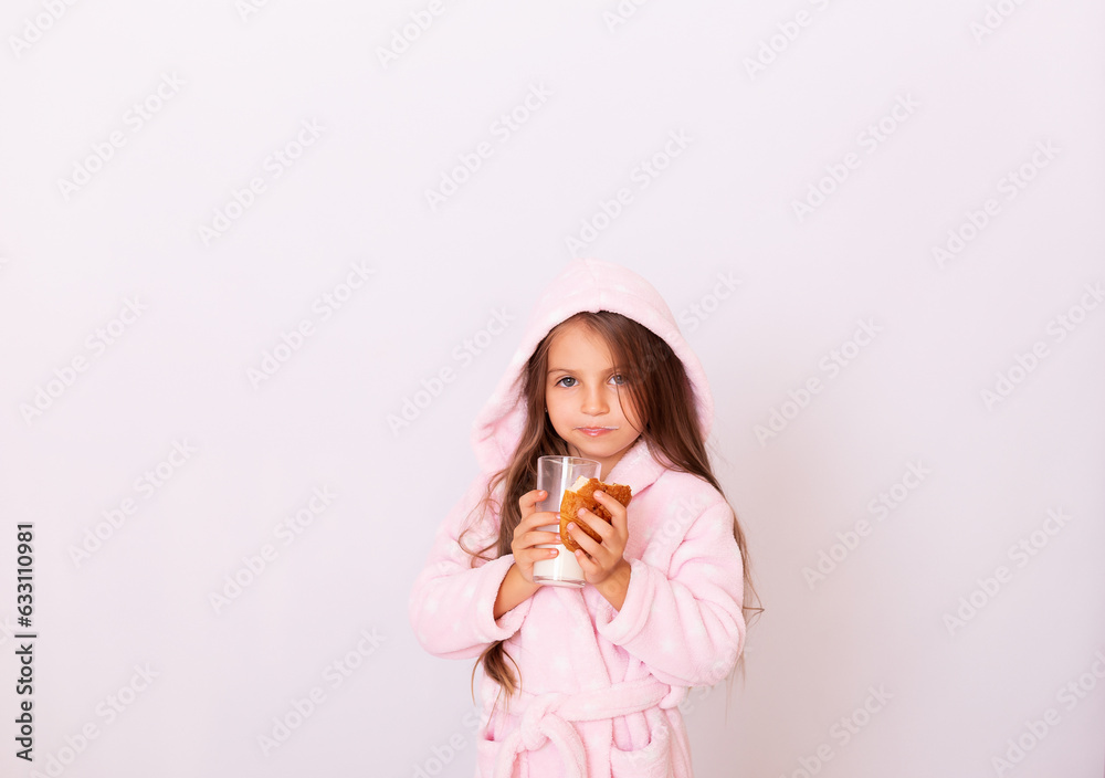 
 Health & Beauty. Little  girl having breakfast, drinking milk. Adorable little girl with towel on the head  biting a croissant and drinking milk on the morning. Paris. Bonjour