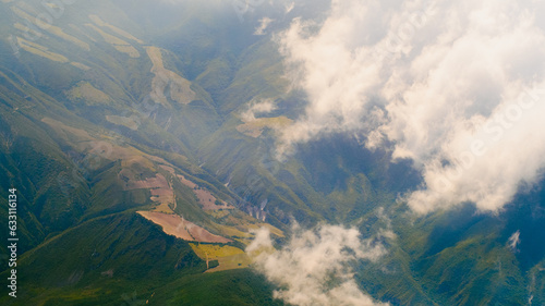 Andes Mountains Pierce the Clouds  Dotted by Vibrant Green Farmland  Ecuador