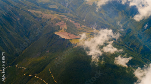 Andes Mountains Pierce the Clouds, Dotted by Vibrant Green Farmland, Ecuador