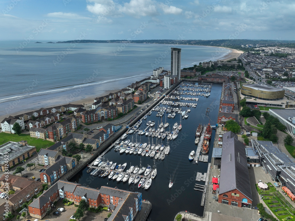 Fototapeta premium Editorial Swansea, UK - August 04, 2023: Drone view from Swansea Marina to Mumbles lighthouse including the new Swansea Arena 