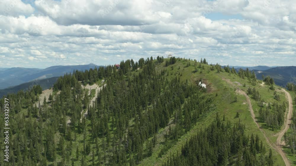 Wide aerial of fire tower on northern Idaho mountain top near Kellogg Wide aerial of fire tower on northern Idaho mountain top near Kellogg