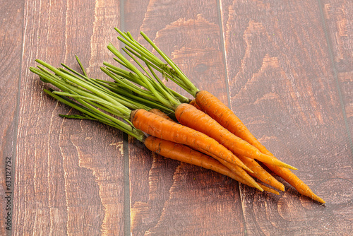 Young raw carrot heap isolated