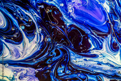 Divorces and patterns of dark, blue and purple paints close-up 
