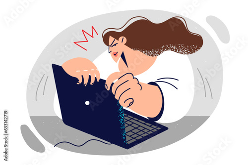 Woman using laptop sits at table and hides screen for fear of compromising confidential information