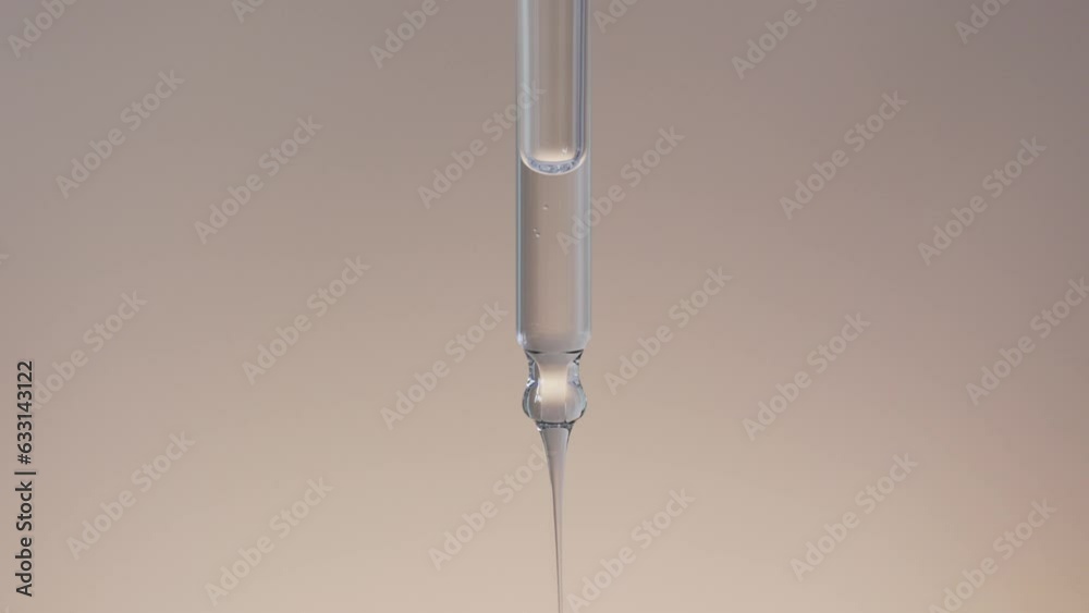 Macro of drop of hyaluronic serum is falling down from chemical dropper 