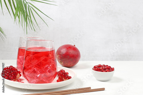 Fruit juice and ingredients, pomegranate summer drink on a bright table, detox diet and weight loss concept, healthy and natural food, vitamin C source, selective focus, photo