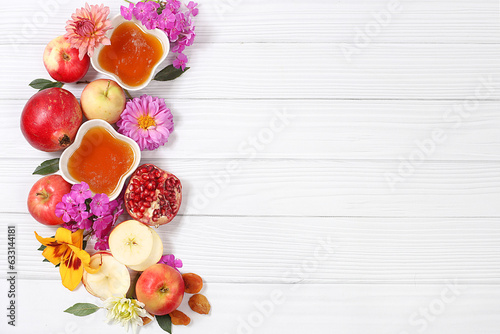 Apples  honey pomegranate and dried apricots on a bright white background The concept of the Jewish holiday Rosh Hashanah top view with a place for your text Jewish New Year and Thanksgiving 