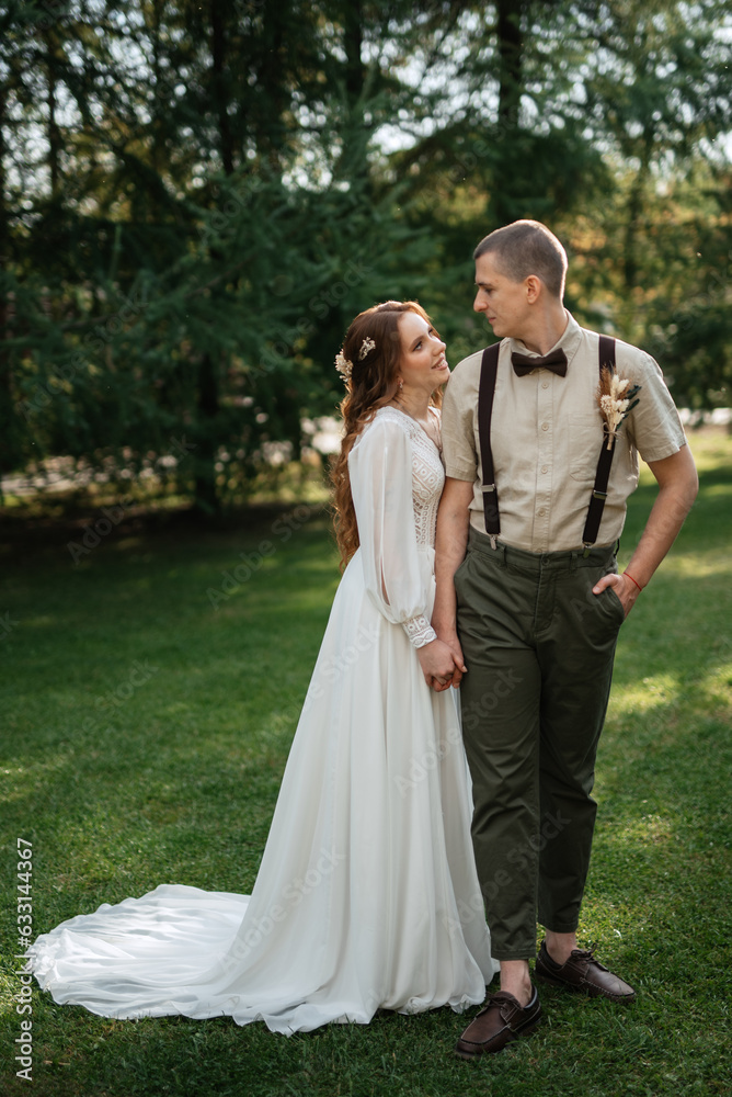 wedding walk of the bride and groom in a coniferous