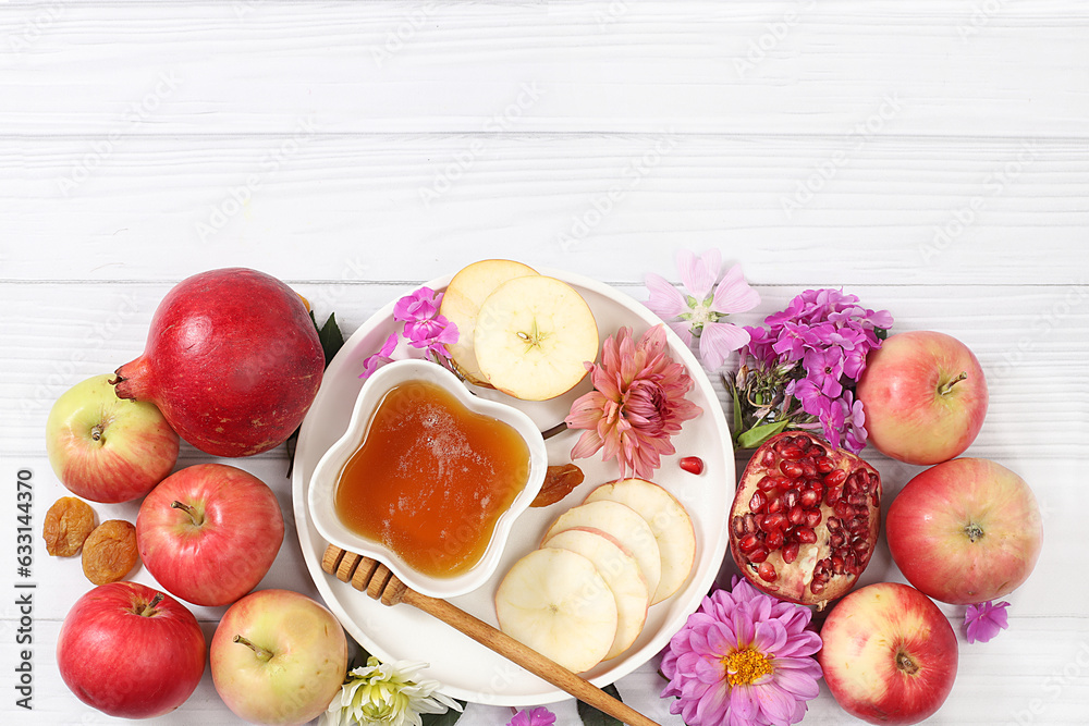 Rosh hashanah jewish holiday concept with apples, honey, pomegranate and dried apricots on bright white background, top view with place for your text, jewish new year and thanksgiving day Rosh hashanah jewish holiday concept with apples, honey, pomegranate and dried apricots on bright white background, top view with place for your text, jewish new year and thanksgiving day