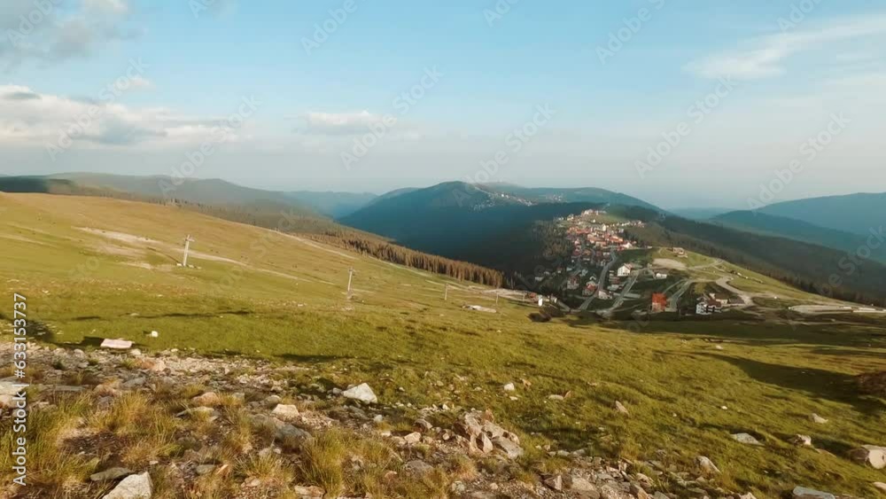 Establishing shot of stunning scenery of a Highlands location featuring a pristine valley, mountain range and quaint village Establishing shot of stunning scenery of a Highlands location featuring a pristine valley, mountain range and quaint village