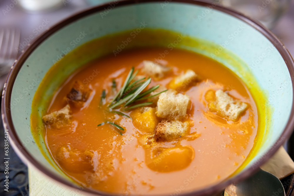 Pumpkin butternut squash soup with Rosemary and rustic croutons in a bowl at a restaurant in Rome Italy Pumpkin butternut squash soup with Rosemary and rustic croutons in a bowl at a restaurant in Rome Italy