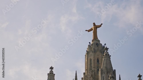 A statue of Jesus on top of a building photo