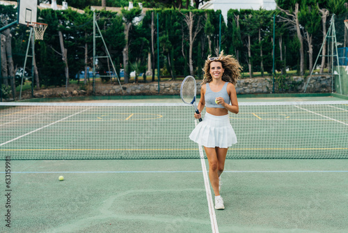 Beautiful blonde girl posing on the tennis court with a racket in her hands. fashion beauty makeup style © sutulastock