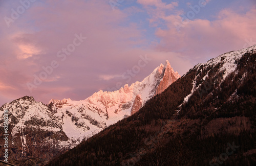 The peak Aiguille du Midi sunset light. View from the city center of Chamonix