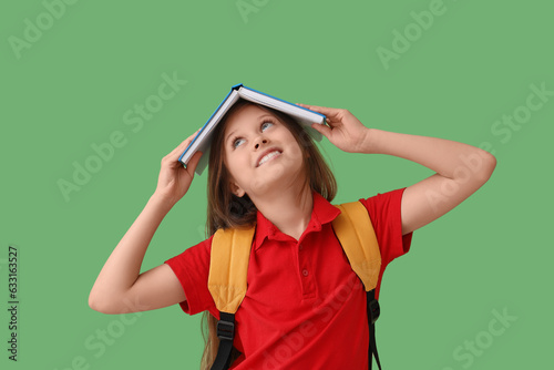 Little schoolgirl with book...