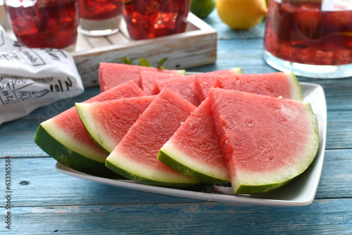 Slices of seedless watermelon on a blue table