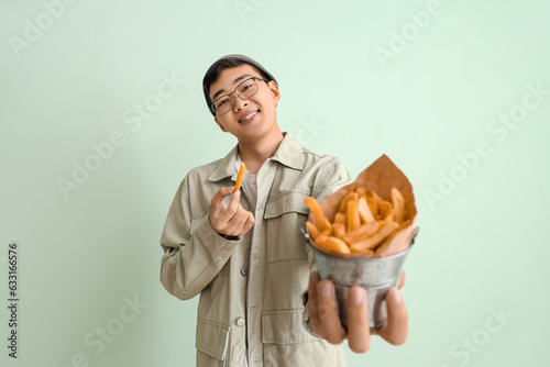 Young Asian man with bucket...