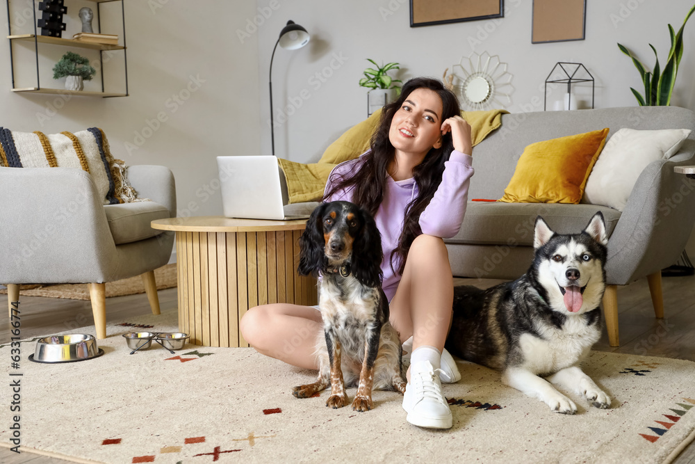 Young woman with cute dogs at home Young woman with cute dogs at home