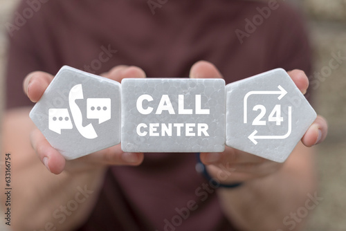Man holding white plastic foam blocks with icons sees text: CALL CENTER. Service call support hotline and call center concept. Hotline support customer service. Online user consultation.