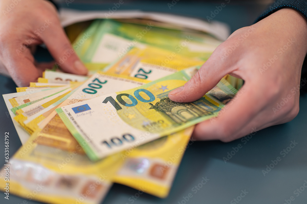 salary in the envelope.Envelope with money.pack of euro bills in an envelope on a gray backgroundExpenses and incomes in European countries.Money and finance.  - obrazy, fototapety, plakaty 