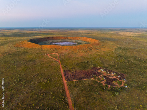 Aerial view of Wolfe Creek Meteorite Crater in the remote Kimberley region of Western Australia. Camp ground in the foreground.