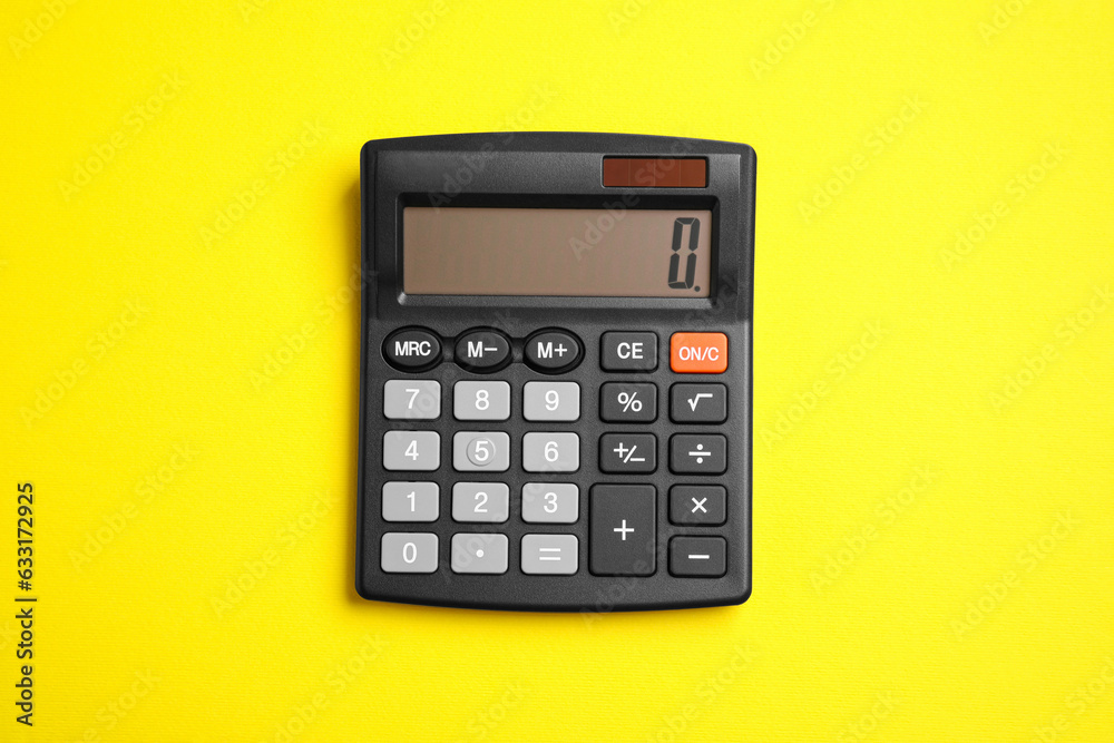 Calculator on yellow background, top view. Office equipment Calculator on yellow background, top view. Office equipment