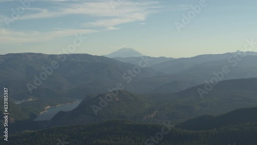 Aerial far view of Mount Saint Helens and Rimrock lake in Washington state in summer at hazy blue sunset photo