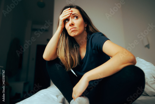 Fotografie Stressed Woman Sitting in Bed Feeling a little Confused