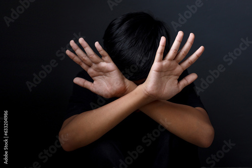 Kid showing hands doing stop gesture. The concept of stopping violence against children. Human Rights Day 