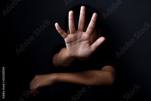 Boy with his hand extended signaling to stop useful to campaign against violence, abuse children  or human trafficking