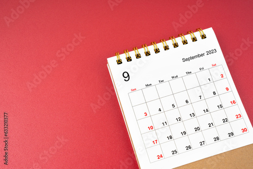 A September 2023 calendar desk for the organizer to plan and reminder isolated on red background.