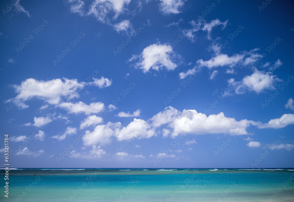 Blue Sky and Cumulus Clouds Above the Ocean in Waikiki, Hawaii.