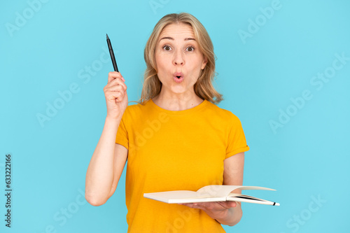 Portrait of female student holding notebook and having good idea