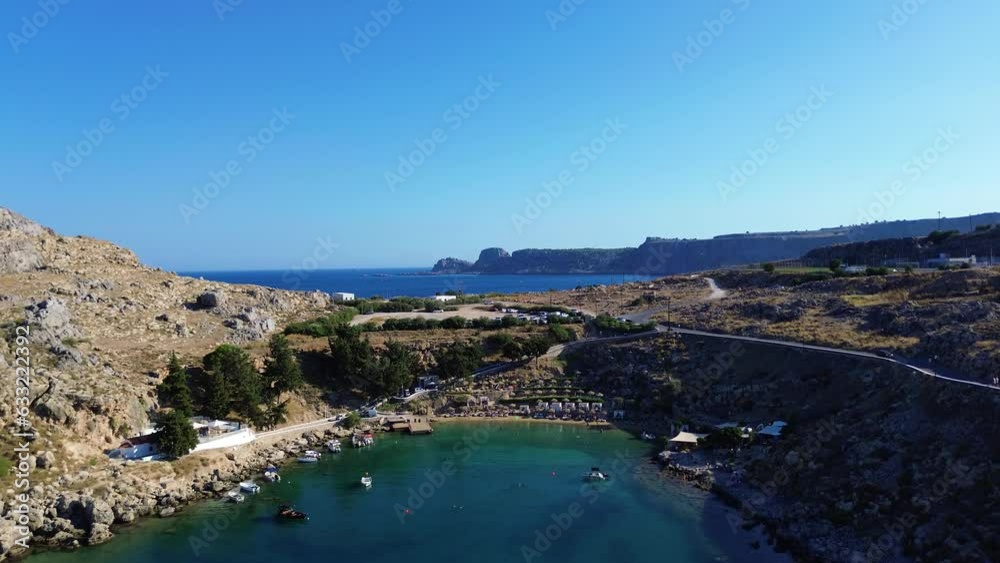 Agios Pavlos beach in Rhodes, Greece with Acropolis of Lindos, houses and Mediterranean sea during the day filmed with the drone Agios Pavlos beach in Rhodes, Greece with Acropolis of Lindos, houses and Mediterranean sea during the day filmed with the drone